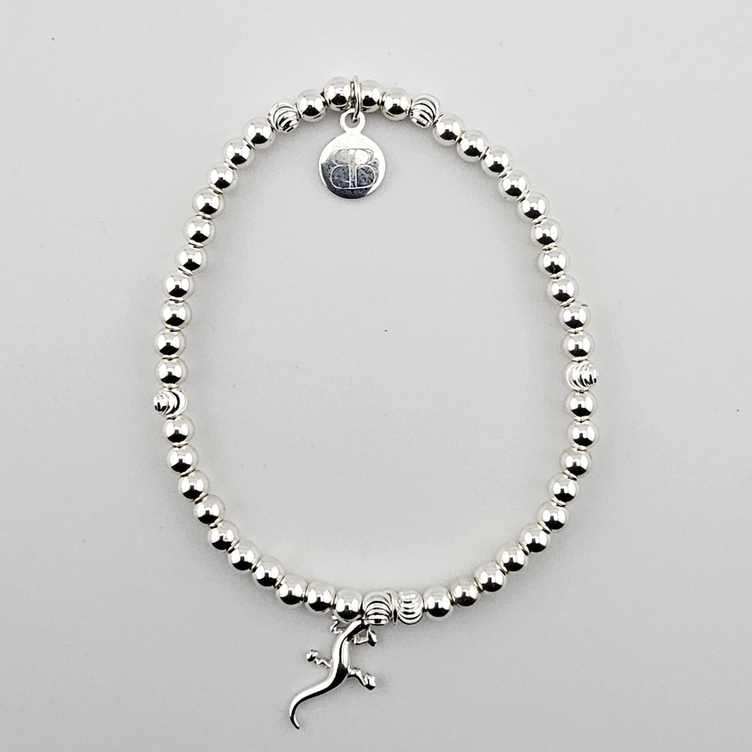 Sterling silver gecko charm bracelet with polished round beads.