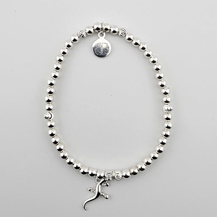 Sterling silver gecko charm bracelet with polished round beads.