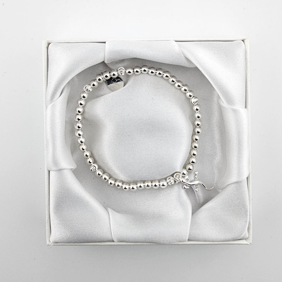 Sterling silver stretch bracelet with gecko charm in satin gift box.