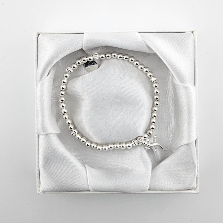 Sterling silver stretch bracelet with gecko charm in satin gift box.