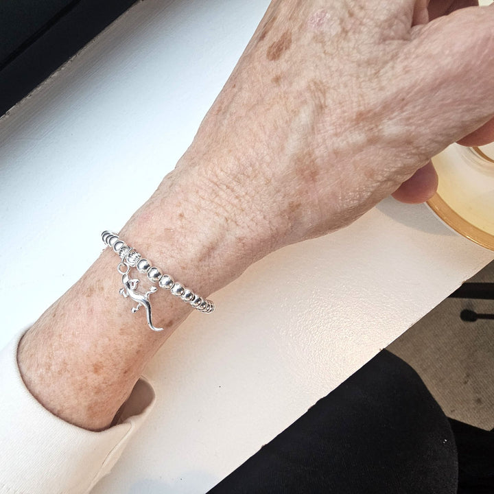 Sterling Silver Gecko Bracelet by Bessie Bae, shown on wrist with polished silver beads and detailed gecko charm.