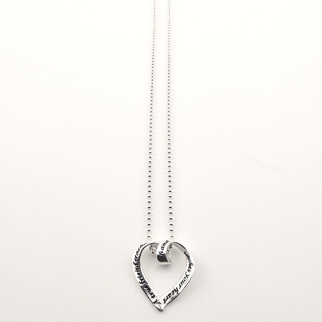 Sterling silver heart pendant necklace with engraved love message on chain.