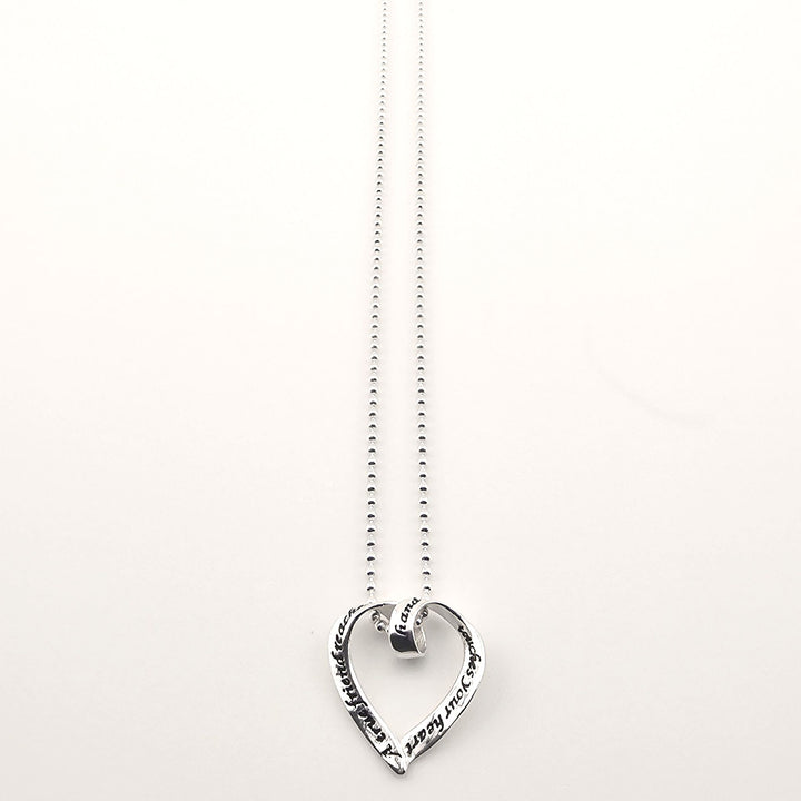 Sterling silver heart pendant necklace with engraved love message on chain.