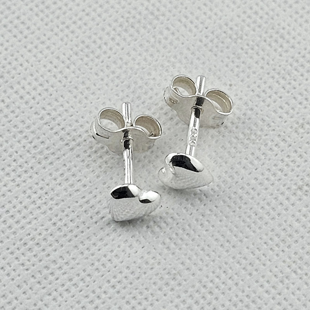 Small sterling silver heart studs for everyday wear.