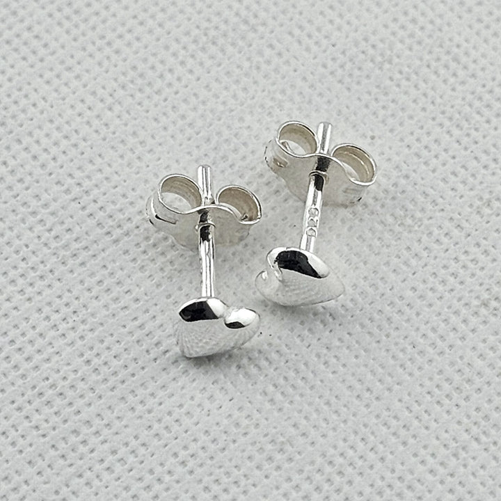 Small sterling silver heart studs for everyday wear.