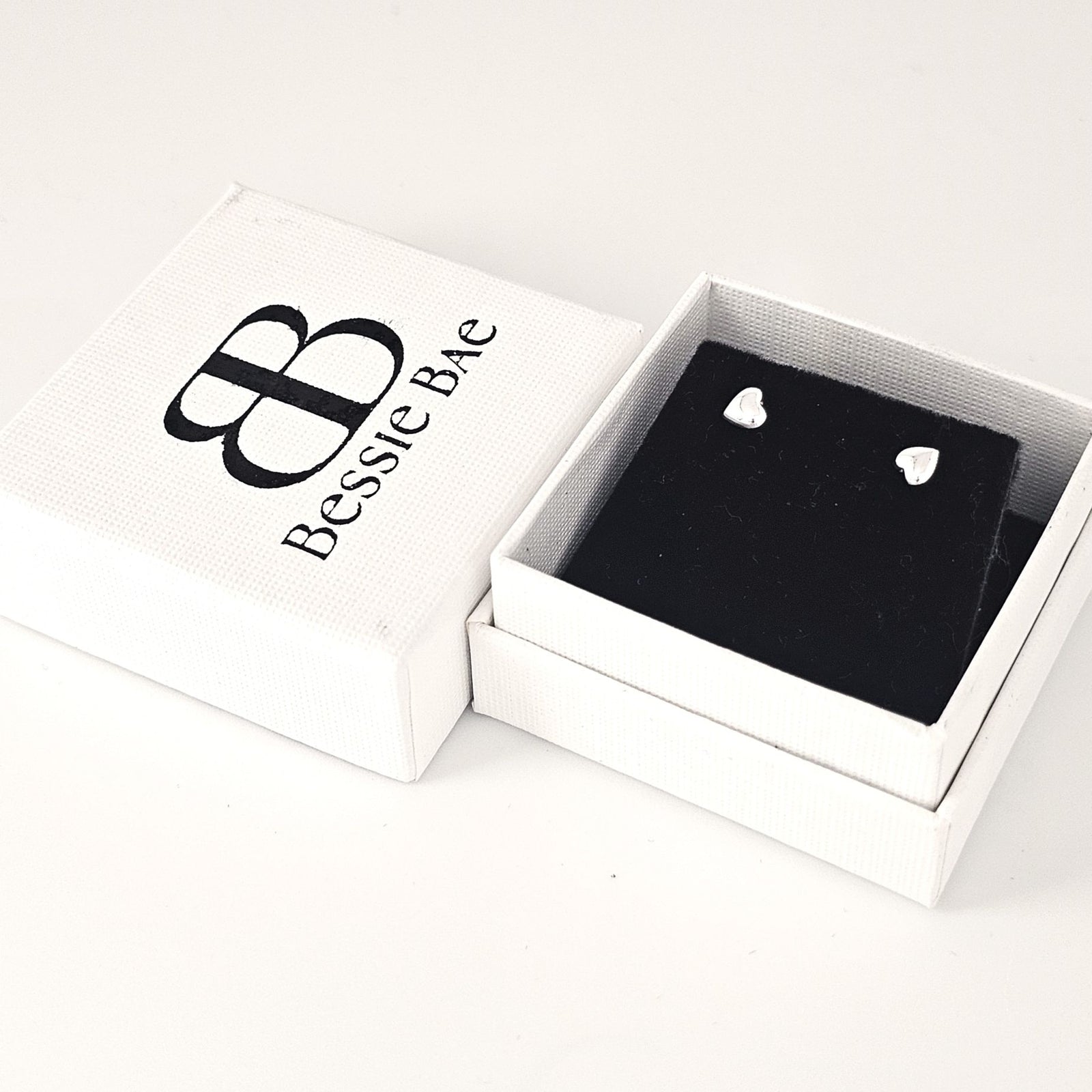 Sterling silver heart stud earrings minimalist design.