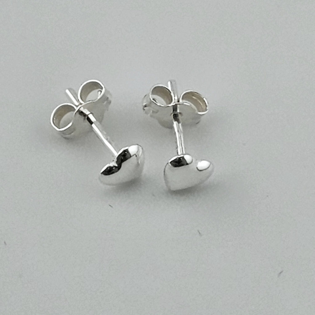 Cute silver heart earrings with butterfly backs.