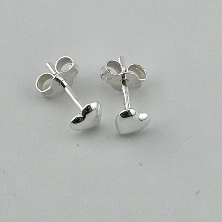 Cute silver heart earrings with butterfly backs.