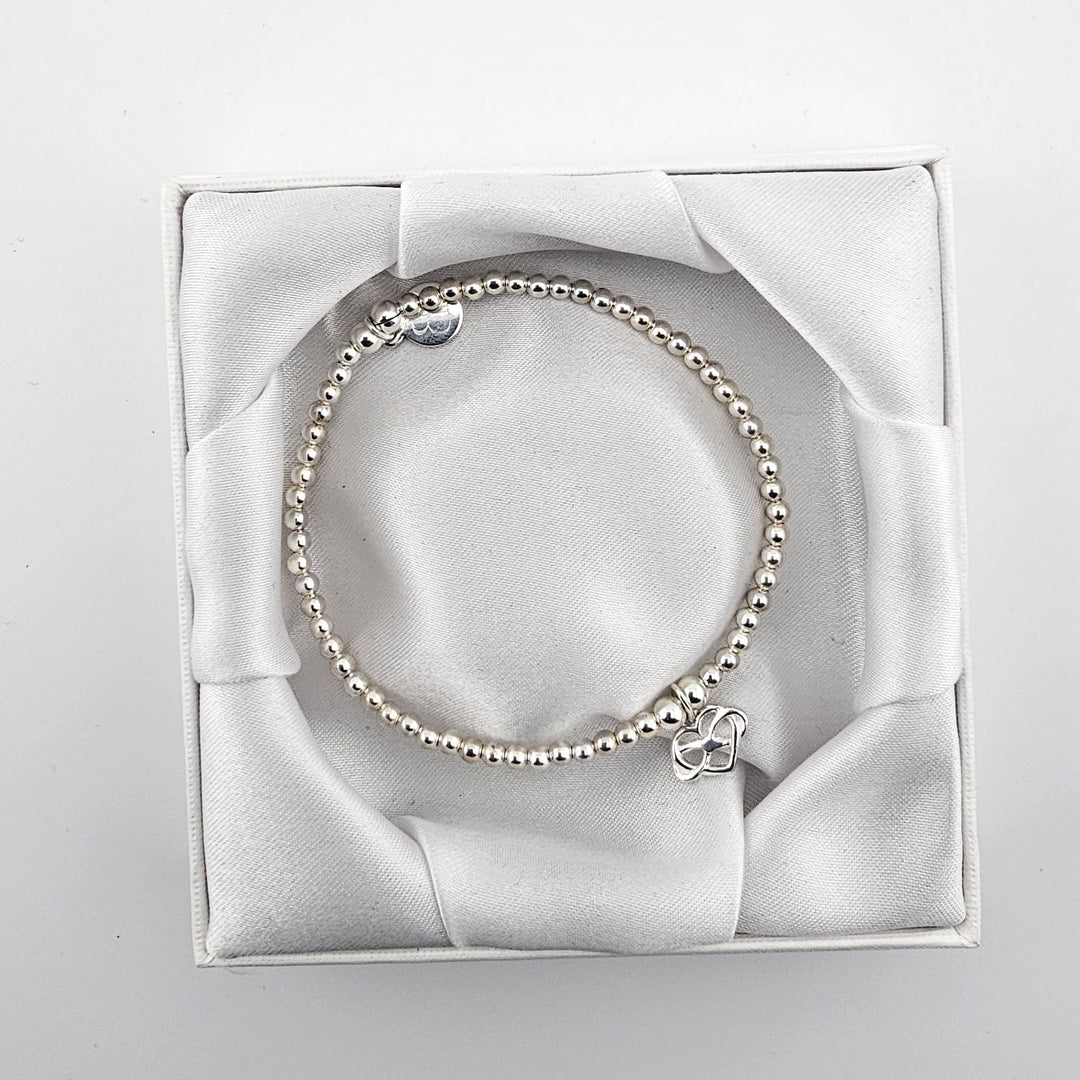 Sterling silver beaded bracelet with heart charm.