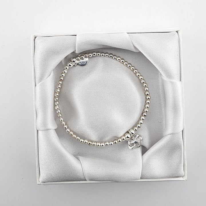 Sterling silver beaded bracelet with heart charm.