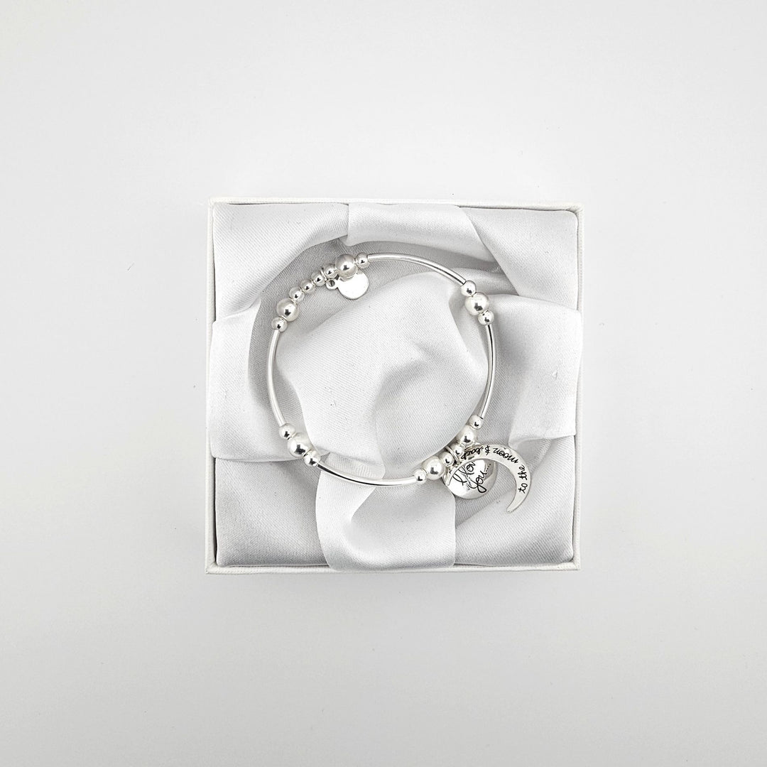 Silver curved tube bracelet featuring engraved moon charm.