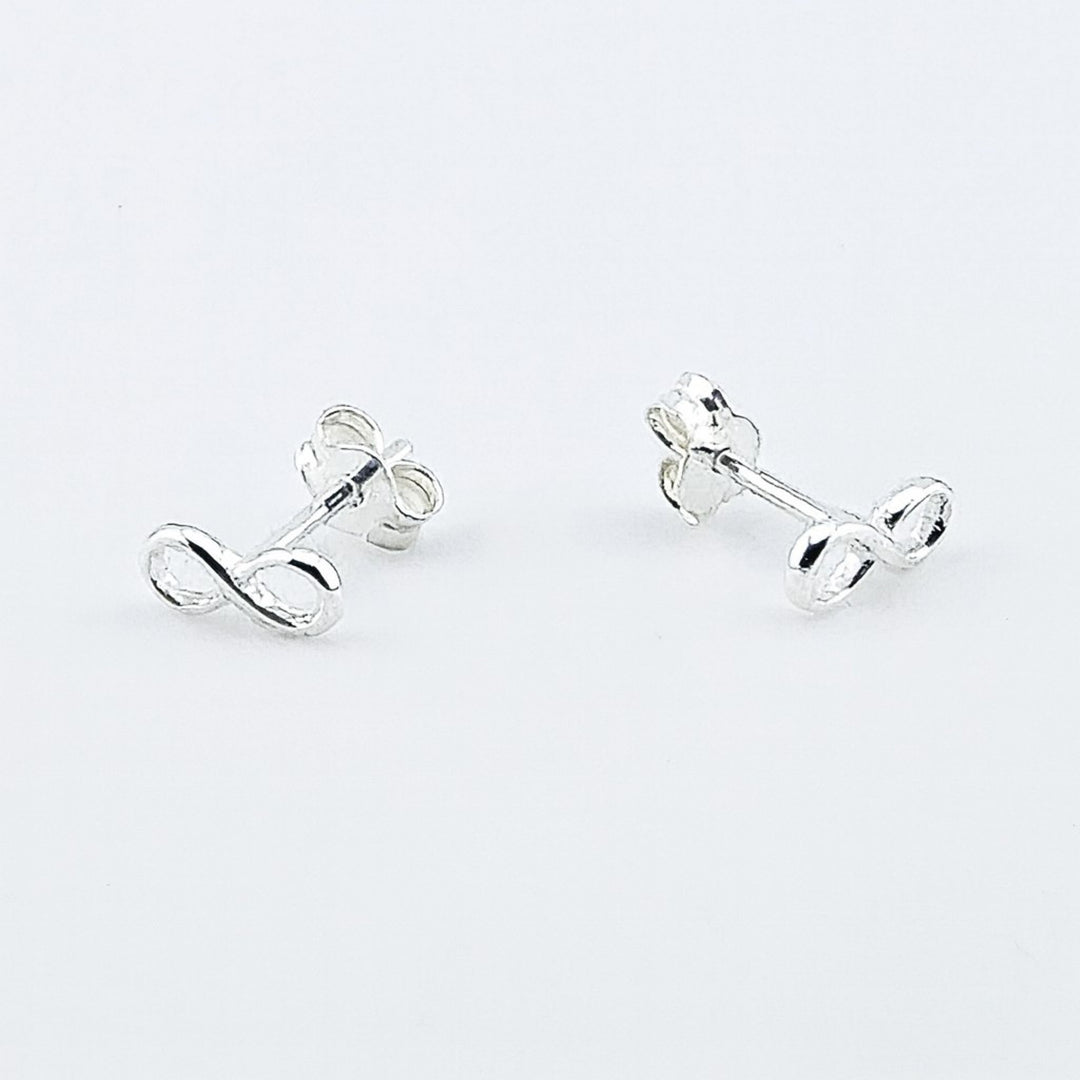Sterling silver infinity stud earrings with butterfly backs.