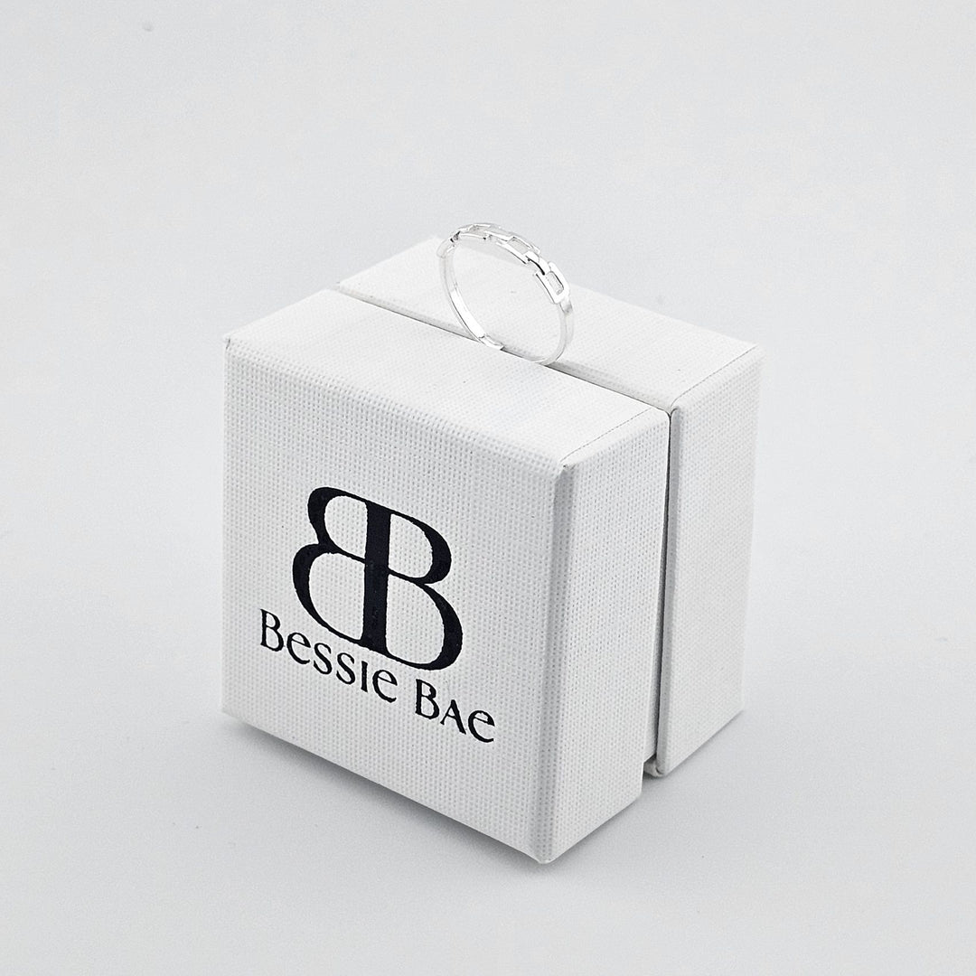 Modern sterling silver link ring with polished finish.