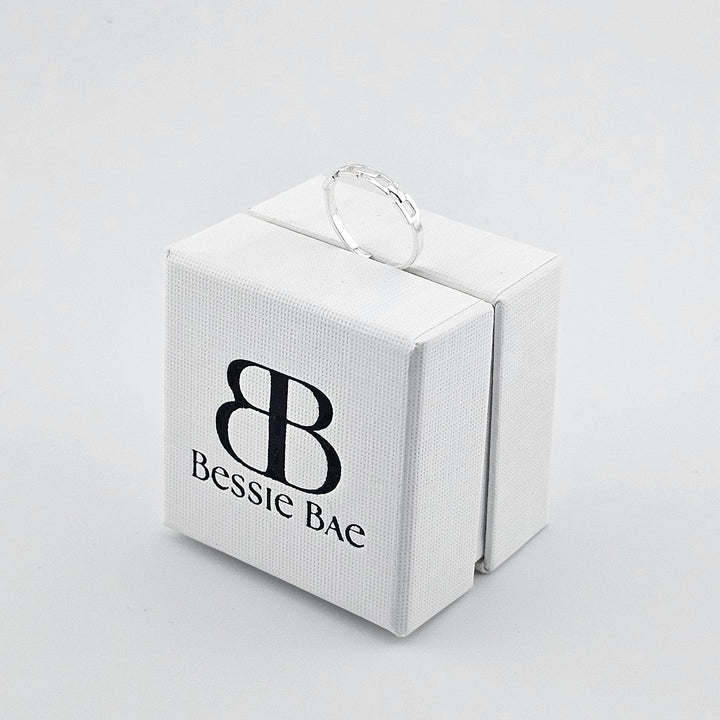 Modern sterling silver link ring with polished finish.