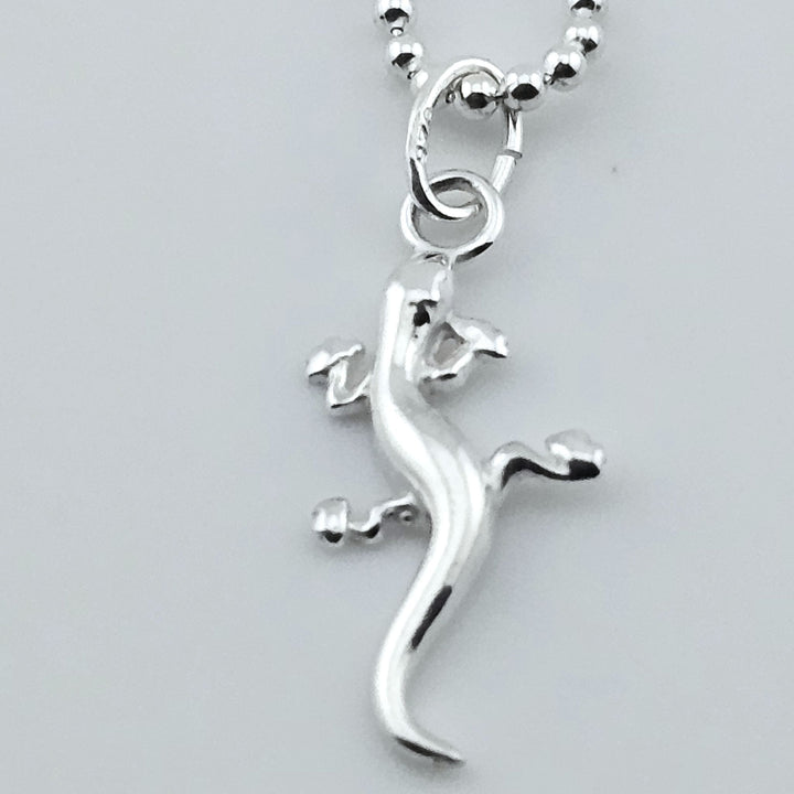 Close-up of sterling silver gecko necklace, animal-inspired jewellery.
