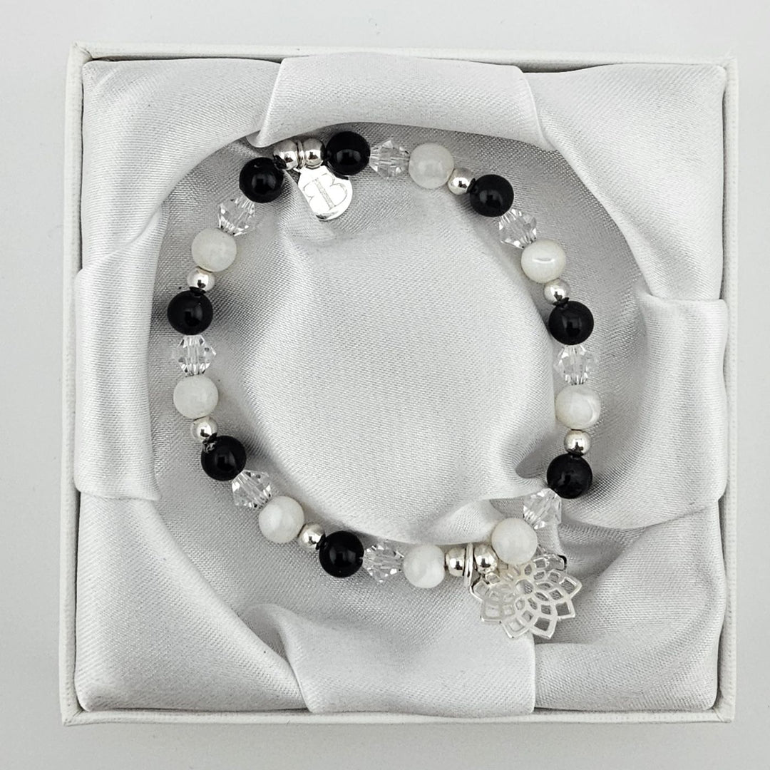 Spiritual beaded bracelet with lotus charm in silver.