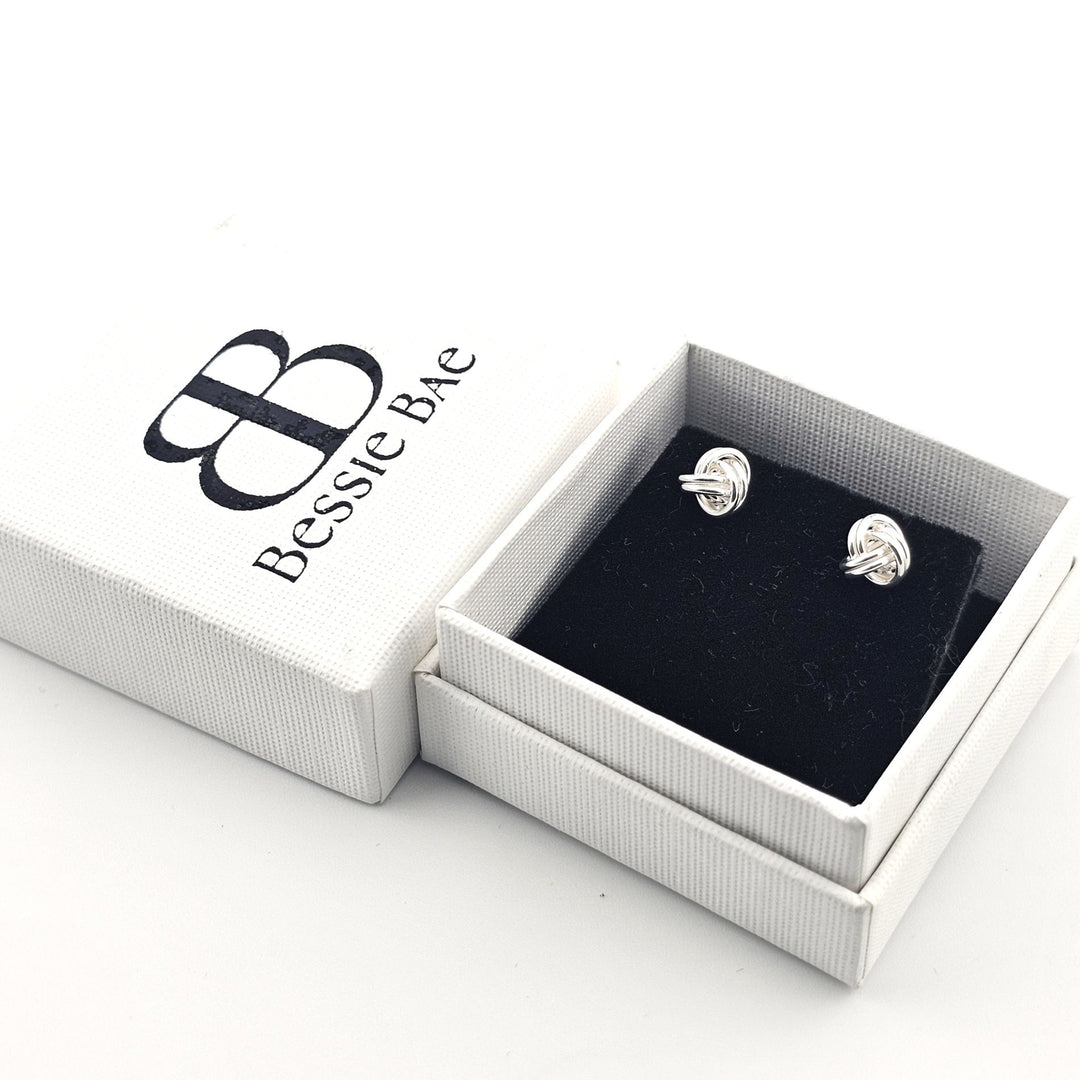 Minimalist sterling silver knot stud earrings.