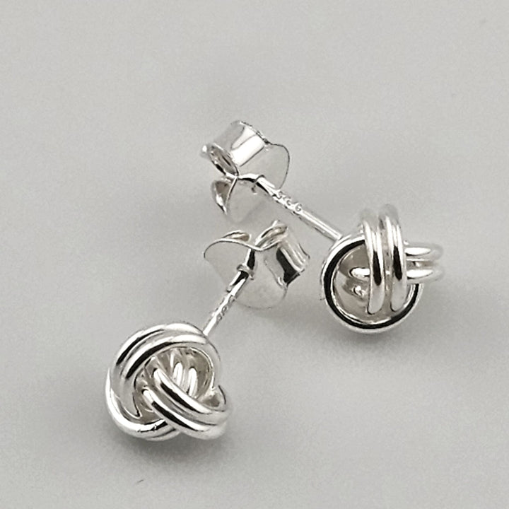 Sterling silver love knot stud earrings for women.