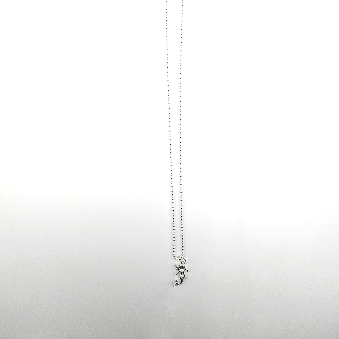 Sterling silver mermaid pendant necklace on a silver ball chain against a white background.