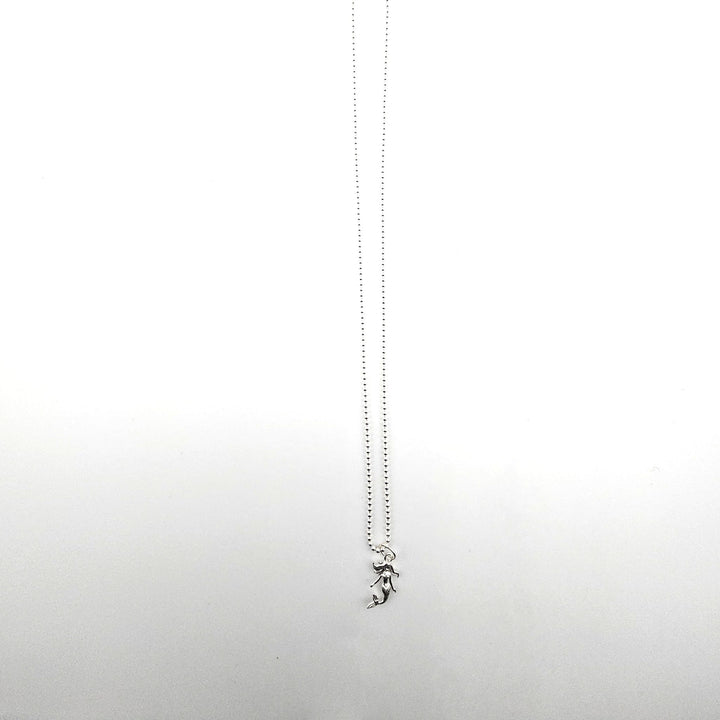 Sterling silver mermaid pendant necklace on a silver ball chain against a white background.