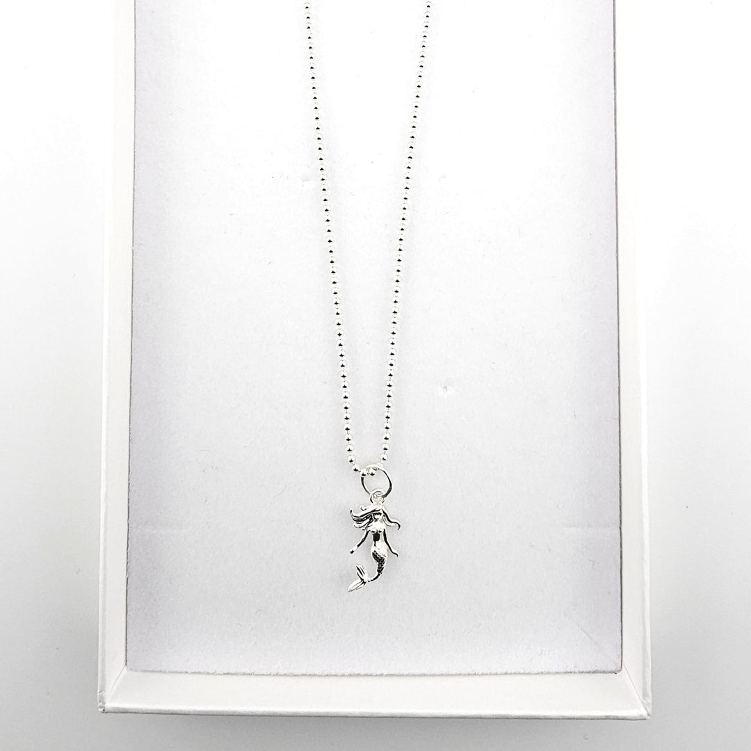 Sterling silver mermaid pendant necklace displayed in a Bessie Bae gift box.