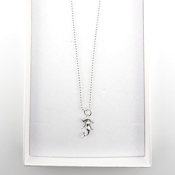 Sterling silver mermaid pendant necklace displayed in a Bessie Bae gift box.