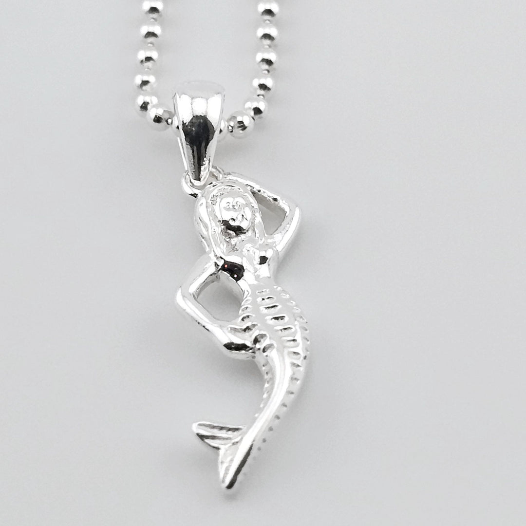 Sterling silver mermaid pendant necklace with ocean-inspired design.