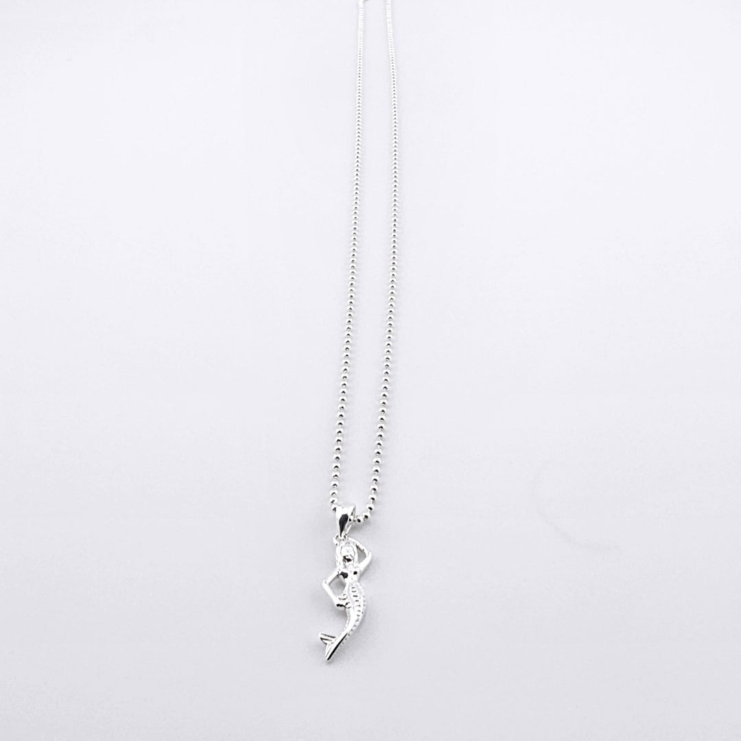 Elegant sterling silver necklace featuring a detailed mermaid pendant.