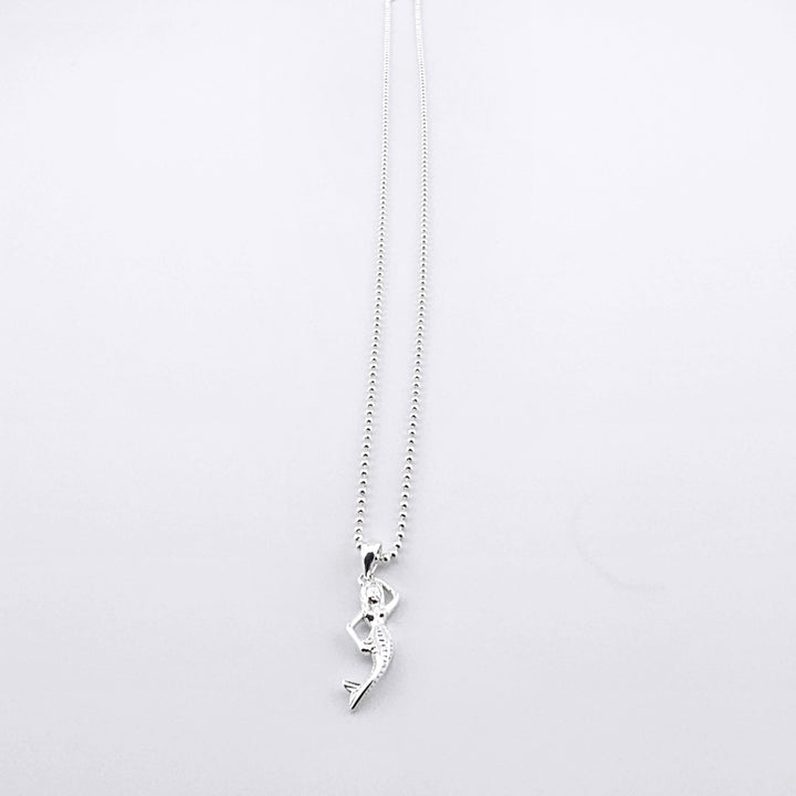 Elegant sterling silver necklace featuring a detailed mermaid pendant.