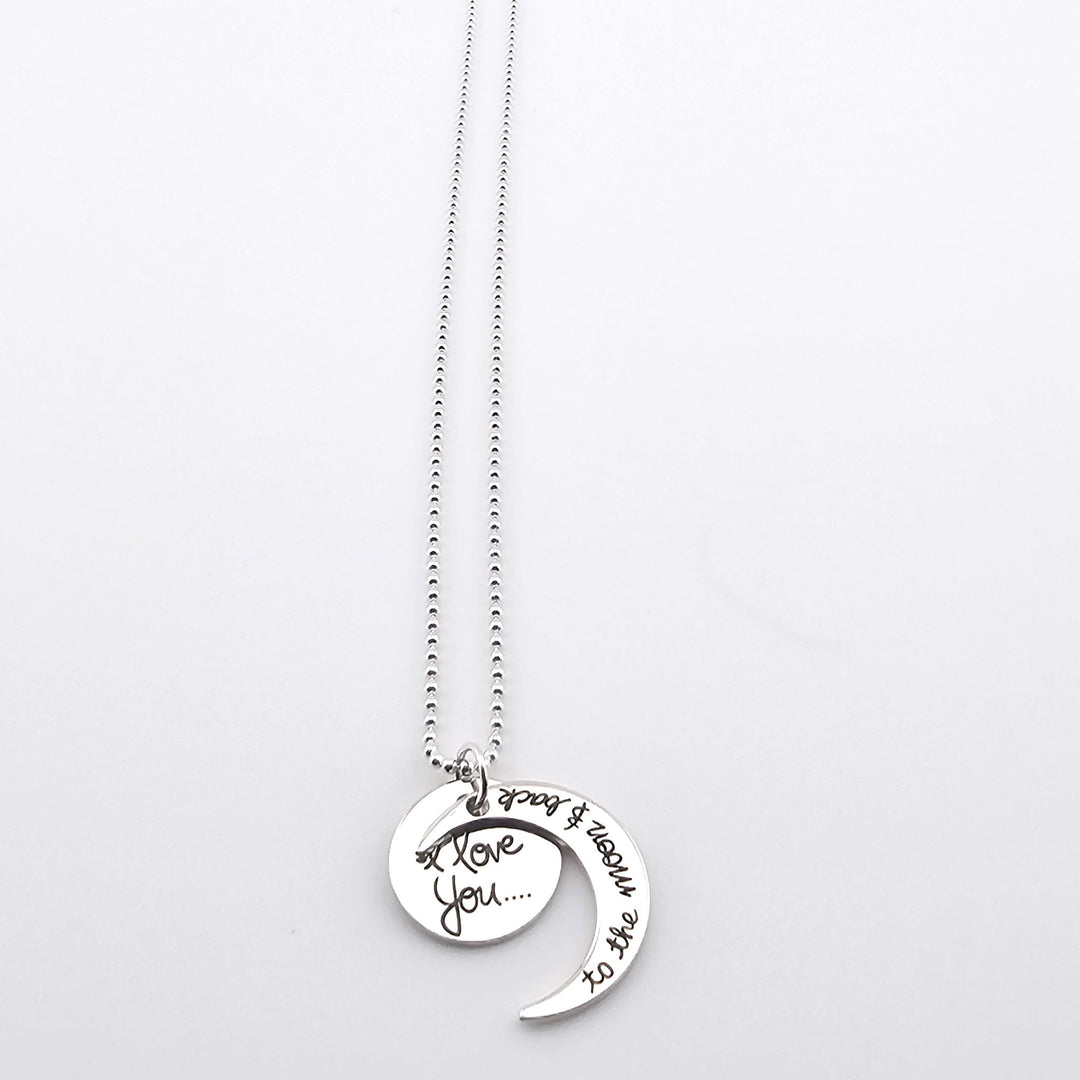 Sterling silver necklace with moon and disc pendants engraved I love you to the moon and back.