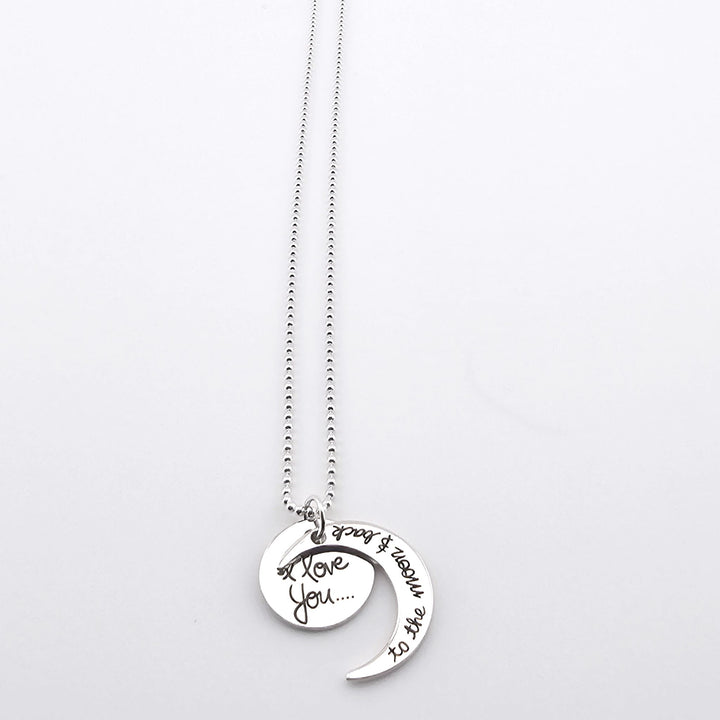 Sterling silver necklace with moon and disc pendants engraved I love you to the moon and back.
