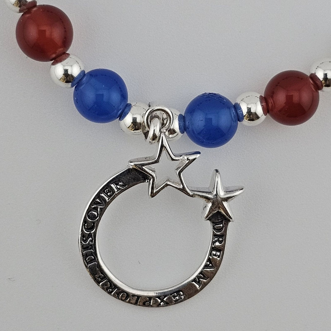 Sterling silver celestial charm bracelet with cosmic design.