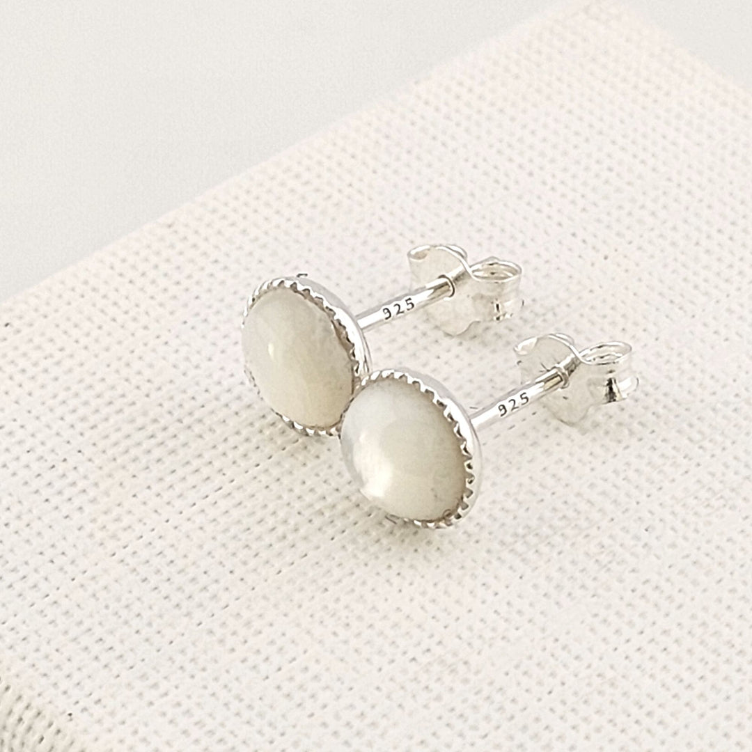 Elegant petite moonstone earrings in polished silver setting.