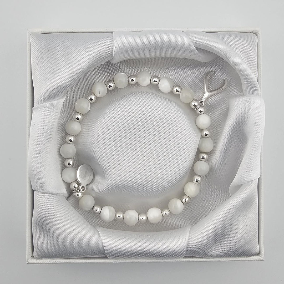 Handmade mother of pearl gemstone bracelet symbolising luck and positivity.
