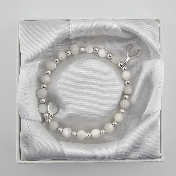 Handmade mother of pearl gemstone bracelet symbolising luck and positivity.