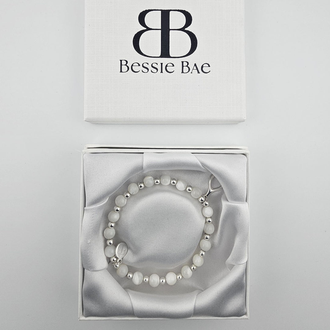 Elegant sterling silver beaded bracelet with wishbone pendant.