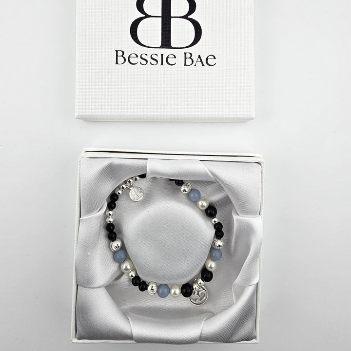 Spiritual bracelet featuring onyx, pearl, and angelite beads.