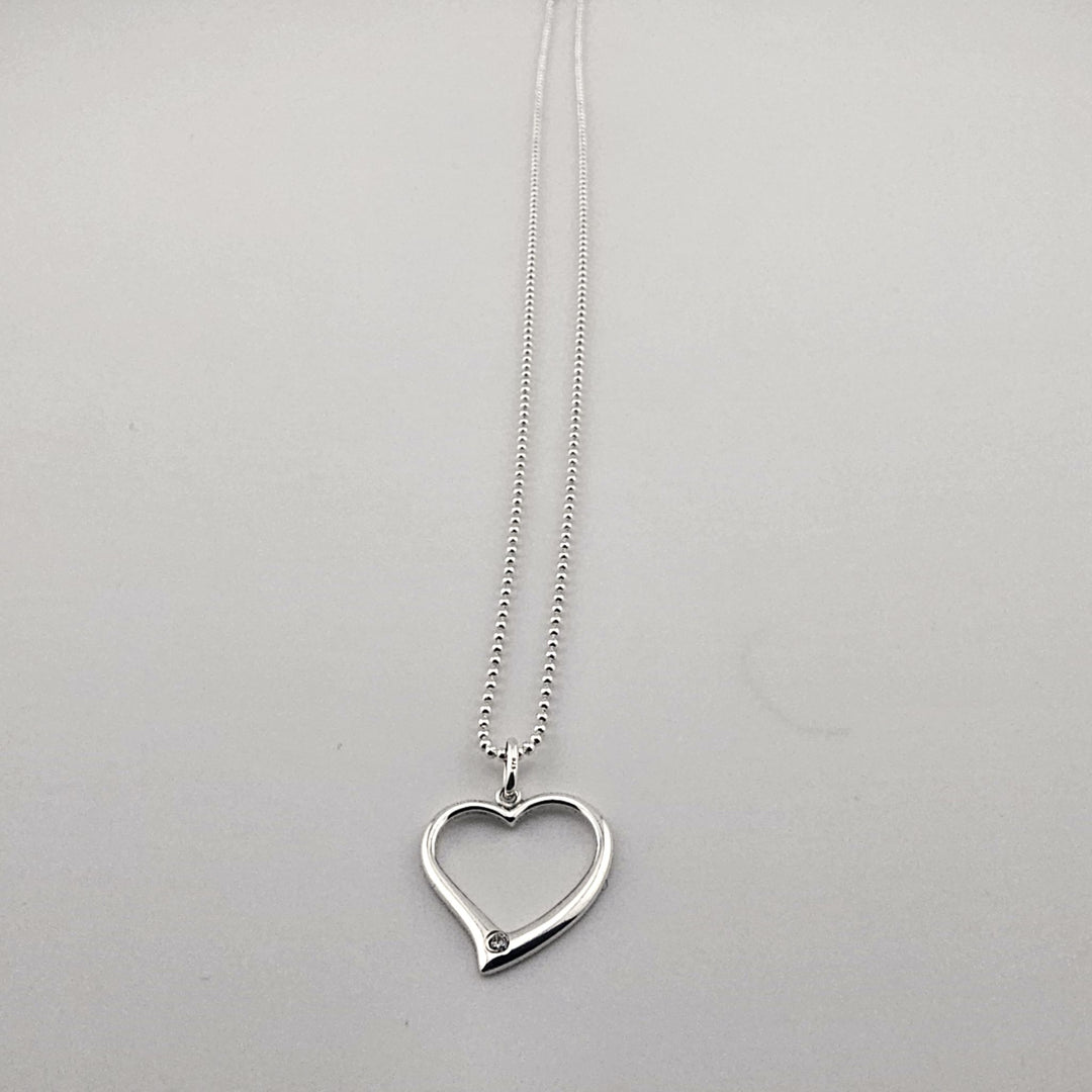 Sterling silver open heart pendant necklace with gemstone accent.
