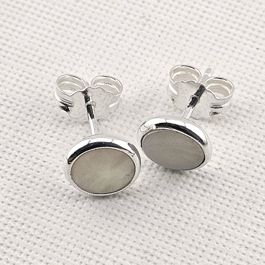 Handcrafted round mother of pearl earrings in sterling silver.