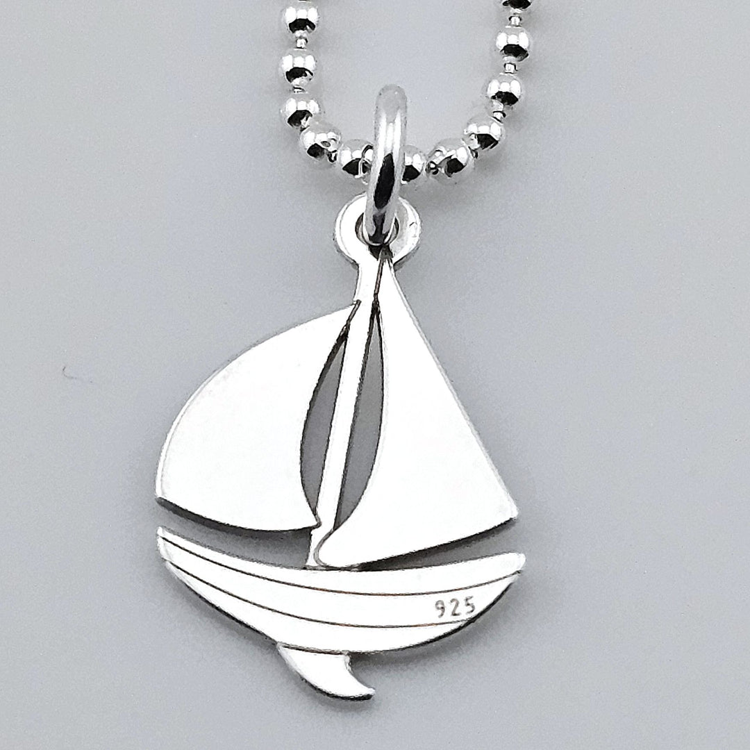 Sterling silver sailboat pendant necklace on fine chain.