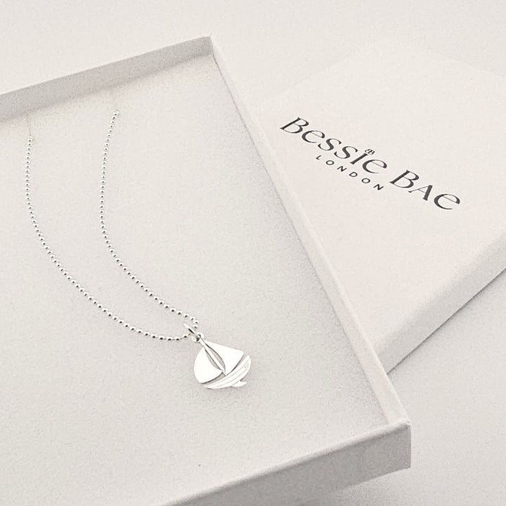 Ocean-inspired sterling silver sailboat necklace, symbolic jewellery gift.