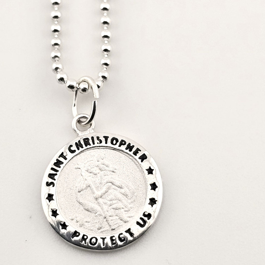 Sterling silver Saint Christopher pendant necklace with Protect Us engraving.