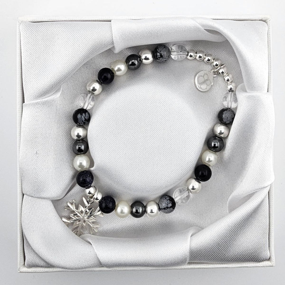 Beaded bracelet with snowflake obsidian and crystal for grounding energy.