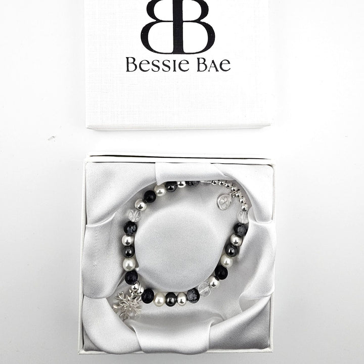 Handmade bracelet with snowflake obsidian, rock crystal, and sterling silver.