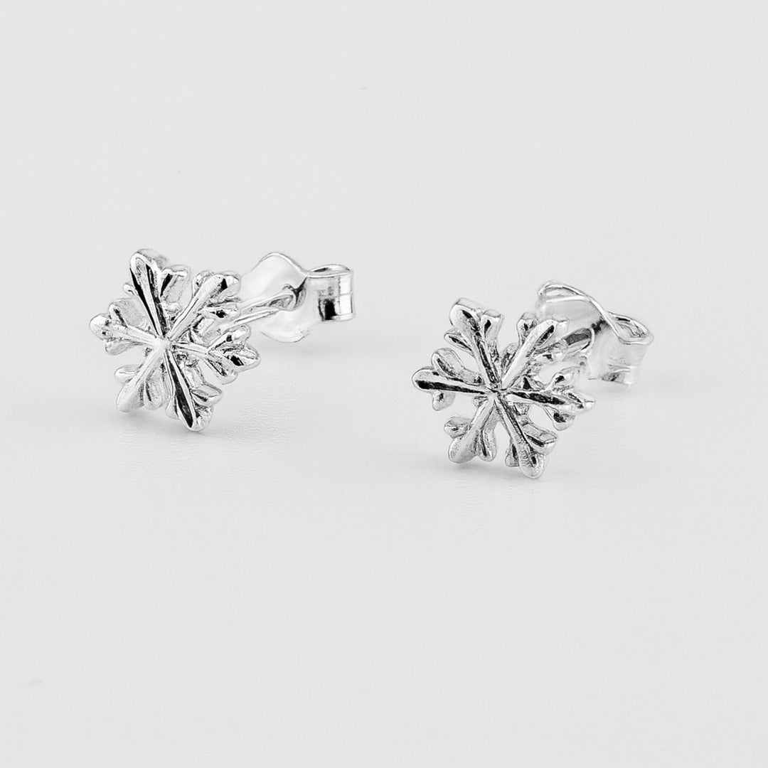 Sterling silver snowflake stud earrings with butterfly backs.
