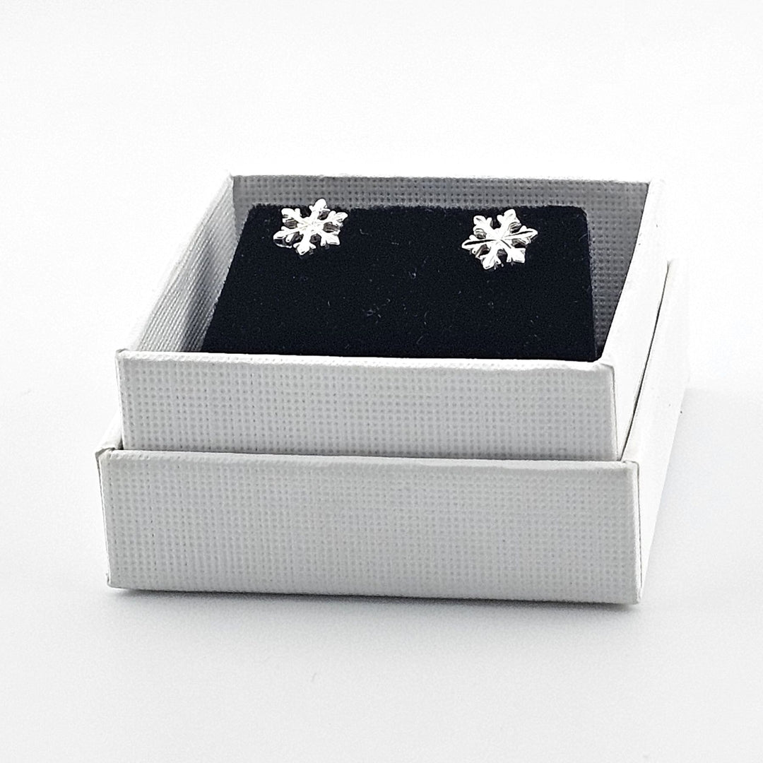 Silver snowflake studs with scroll fittings.