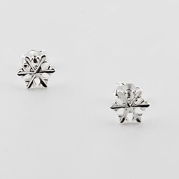 Dainty winter snowflake earrings in sterling silver.