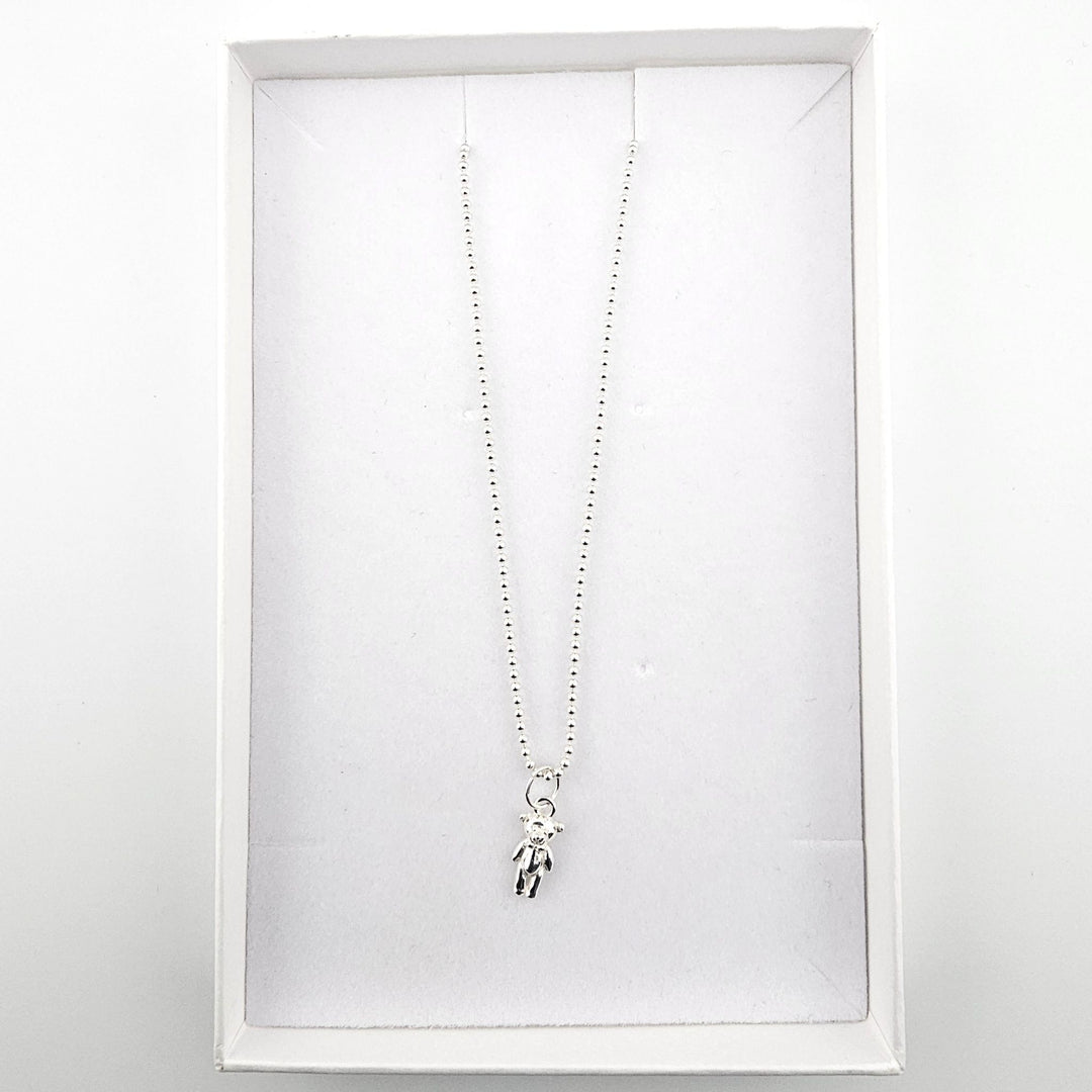 Sterling silver teddy bear pendant necklace presented in a white jewellery gift box.