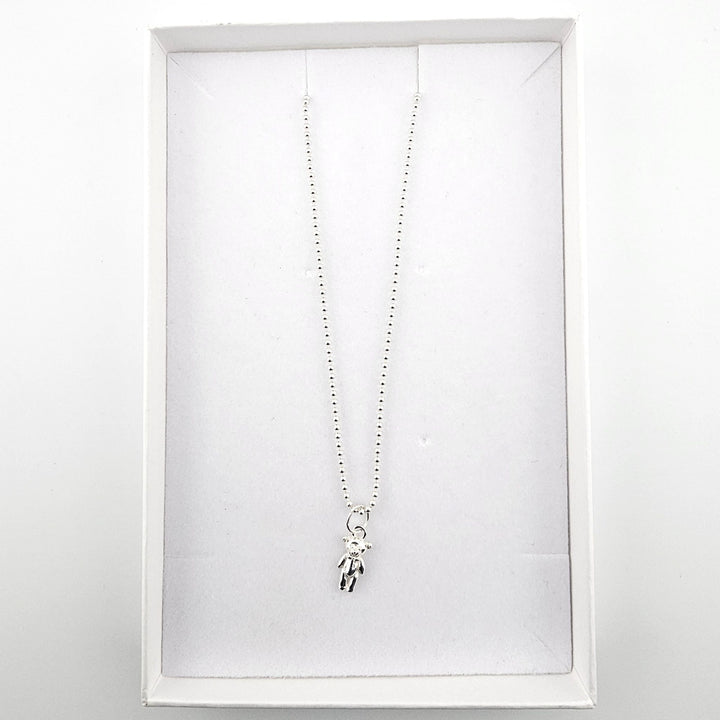 Sterling silver teddy bear pendant necklace presented in a white jewellery gift box.