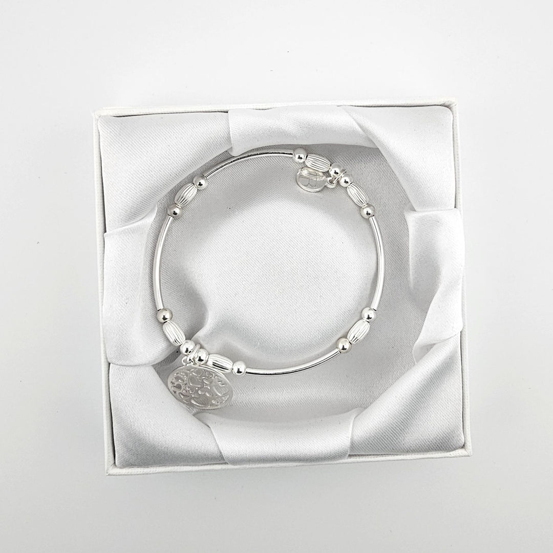Sterling silver oval bead bracelet with heart charm.